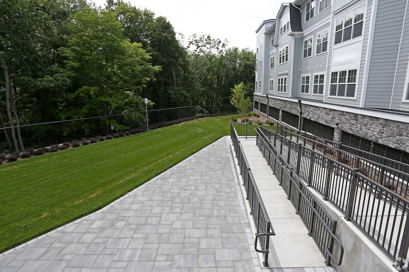 Paver walkway alongside the stone-base building