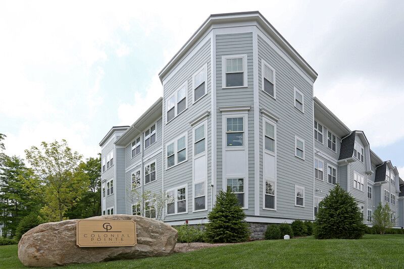 Building elevation with Colonial Pointe monument sign